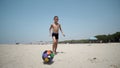 Young boy at the beach plays with a soccer Royalty Free Stock Photo