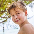 Young boy at the beach is smiling and looking self confident Royalty Free Stock Photo