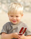 Young boy on the beach with telephone