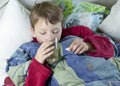Young boy in bed taking his medicin Royalty Free Stock Photo