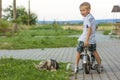 Young boy on a bicycle and sleeping dog Royalty Free Stock Photo