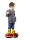 Young boy with big clown shoes Royalty Free Stock Photo