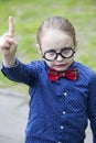 Young boy with big glasses lifting his finger Royalty Free Stock Photo