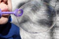 Young boy blowing bubbles from bubble maker close up view Royalty Free Stock Photo