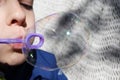 Young boy blowing bubbles from bubble maker close up view Royalty Free Stock Photo