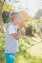 Young boy blowing bubbles through bubble wand Royalty Free Stock Photo