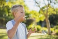 Young boy blowing bubbles through bubble wand Royalty Free Stock Photo