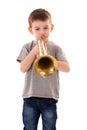 Young boy blowing into a trumpet Royalty Free Stock Photo