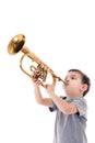 Young boy blowing into a trumpet Royalty Free Stock Photo