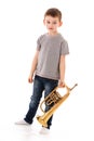 Young boy blowing into a trumpet Royalty Free Stock Photo