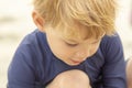 Preschool aged boy in a blue swimming suit at the beach, close up of face Royalty Free Stock Photo