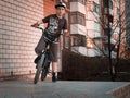 Young boy bmx rider on a ramp with urban background at sunset Royalty Free Stock Photo