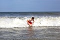 Young boy is body surfing in the waves Royalty Free Stock Photo