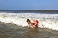 Young boy is body surfing in the waves Royalty Free Stock Photo