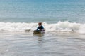 Young boy boogie boarding on a wave. Royalty Free Stock Photo