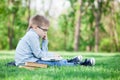 Young boy with a book and laptop computer Royalty Free Stock Photo