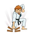 Young Boy Breaking Boards in Karate Uniforms