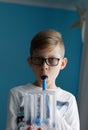 Young boy breaths deep exercise with incentive spirometer