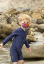 Young boy in a bright face mask playing in tidepools Royalty Free Stock Photo