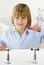 Young Boy Brushing Teeth at Sink Royalty Free Stock Photo