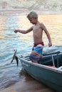 Young Boy Catches a Fish Royalty Free Stock Photo