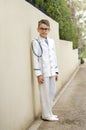 Young boy celebrating his first holy communion wearing a sailor suit