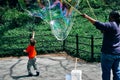 Young boy chases large balloon in Central Park.