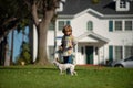 Young boy child with dog playing in garden. Royalty Free Stock Photo