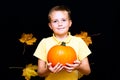 Young boy child kid holding natural organic pumpkin in hands. close up photos smiling face Royalty Free Stock Photo