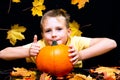 Young boy child kid holding natural organic pumpkin in hands thumb up close up photos smiling face