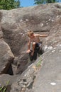 A young boy climbing and exploring among a mountain of rocks Royalty Free Stock Photo
