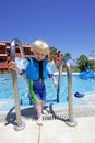 Young boy climbing out of swimming pool on vacation Royalty Free Stock Photo