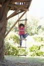 Young Boy Climbing Rope Ladder To Treehouse Royalty Free Stock Photo