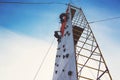 Young boy climbing up an artificial rock wall Royalty Free Stock Photo