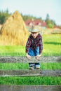 Young boy climbs over wooden fence look straight, close up