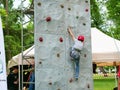 Young boy climbs a rock climbing wall Royalty Free Stock Photo