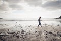 Young Boy Collecting Litter On Winter Beach Clean Up