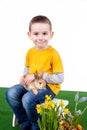 Young boy with colorful rabbit and spring flower Royalty Free Stock Photo