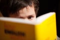 Young boy concentrating on reading a book Royalty Free Stock Photo