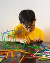 A young boy is constructing colorful plastic sticks. fun with building geometric figures and learning mathematics at home Royalty Free Stock Photo