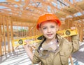 Young Boy Contractor With Level On Site Inside New Home Construction Framing. Royalty Free Stock Photo