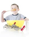 Young boy cooking and tasting Royalty Free Stock Photo