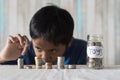 Young boy counting his coins/savings to buy dream toys. Royalty Free Stock Photo