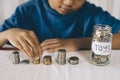 Young boy counting his coins/savings to buy dream toys. Royalty Free Stock Photo