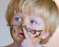 Young boy covered in face paint