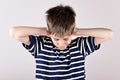 Young boy covering his ears with hands