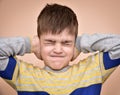 Young boy covering his ears with hands Royalty Free Stock Photo