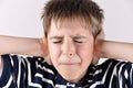 Young boy covering his ears with hands Royalty Free Stock Photo