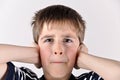 Young boy covering his ears with hands Royalty Free Stock Photo