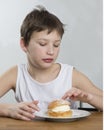 Young boy with cream bun